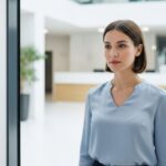 Employee using face recognition scanner at office entrance