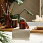 Spa-like bathroom setup with towels, candles, and bath essentials