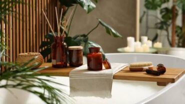 Spa-like bathroom setup with towels, candles, and bath essentials