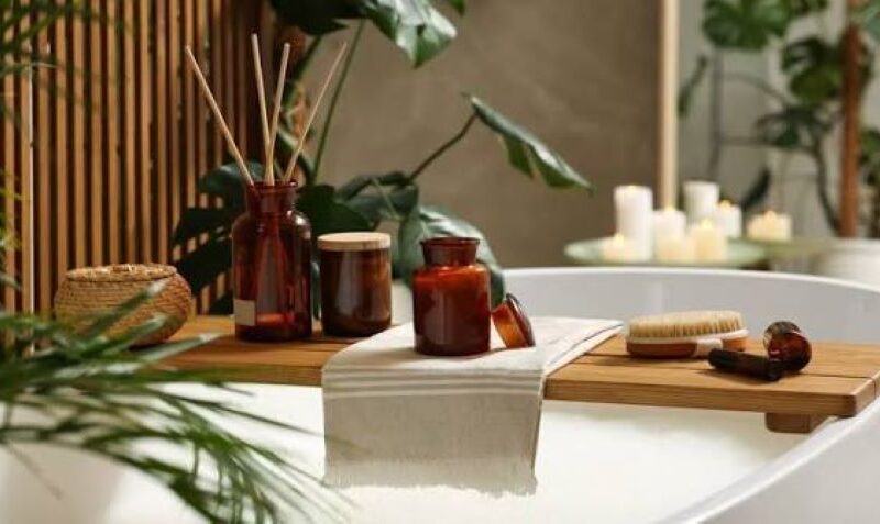 Spa-like bathroom setup with towels, candles, and bath essentials